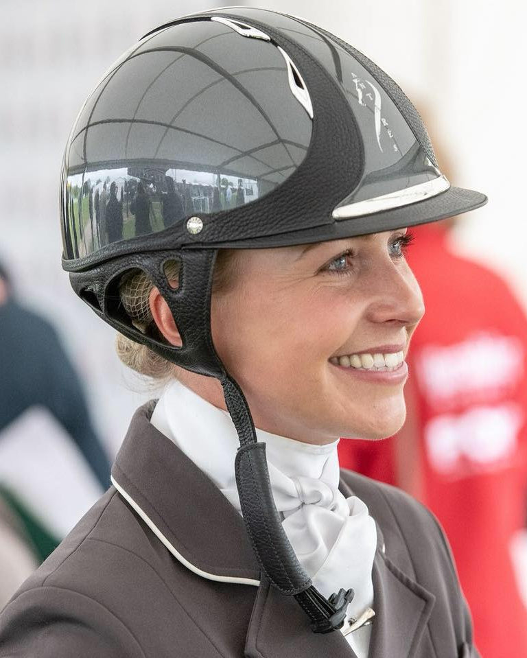 Georgie Campbell smiling wearing competition helmet and show jacket