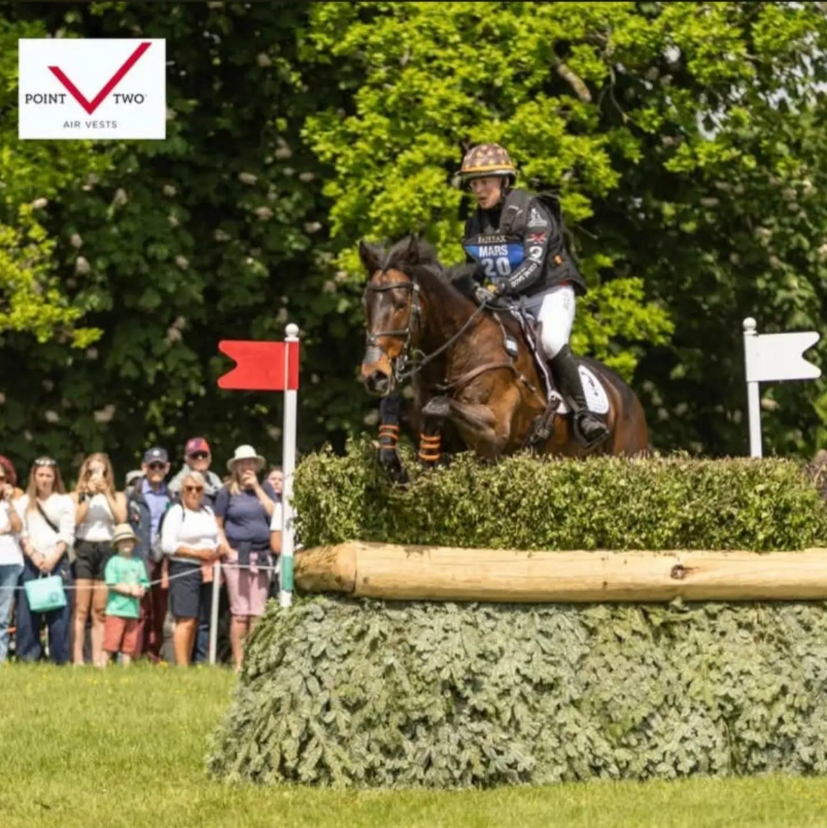 Tom Bird jumping a cross country fence wearing a Point Two air vest.